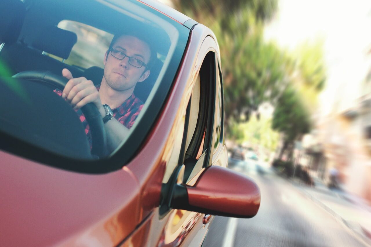 Man performing a driving test manoeuvre in his car.