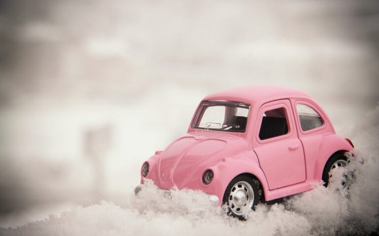 A toy VW Beetle stuck in the snow, symbolising the problems with pulling off in difficult weather conditions.