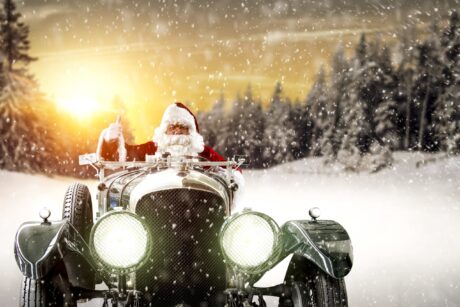 Picture showing Santa driving a car through the snow